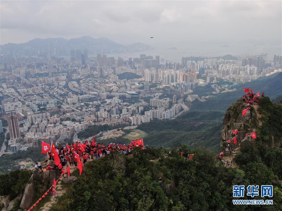 百余名香港市民爬上狮子山顶挥舞国旗、区旗